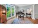 Charming living room with a grand piano, hardwood floors, and large windows at 100 Castlebrook Chase, Tyrone, GA 30290