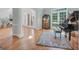 Spacious living room featuring a grand piano, natural light, hardwood flooring and a decorative rug at 100 Castlebrook Chase, Tyrone, GA 30290