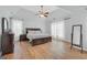 Spacious main bedroom boasts a tray ceiling, ceiling fan, and hardwood floors at 100 Castlebrook Chase, Tyrone, GA 30290