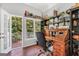 Inviting home office with natural light, wood floors, vintage desk, and balcony at 100 Castlebrook Chase, Tyrone, GA 30290