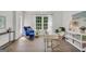 Bright home office featuring hardwood floors, white walls, and a large window at 100 Castlebrook Chase, Tyrone, GA 30290