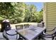 Spacious outdoor patio featuring a fireplace and dining table with chairs perfect for backyard entertainment at 100 Castlebrook Chase, Tyrone, GA 30290