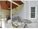 Relaxing porch with furniture, ceiling fan, and wood ceiling that offers a comfortable outdoor living space at 100 Castlebrook Chase, Tyrone, GA 30290
