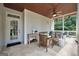 Relaxing porch with furniture, ceiling fan, and door leading to a beautiful backyard at 100 Castlebrook Chase, Tyrone, GA 30290