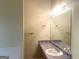Bathroom includes a single sink, large mirror with vanity lighting, and towel rack at 2561 Lancewood Ln, Lithonia, GA 30035