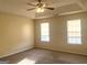 Spacious bedroom with tray ceilings, a ceiling fan, and large windows bringing in plenty of light at 2561 Lancewood Ln, Lithonia, GA 30035