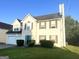 Two-story home with a two-car garage, lawn, and tidy landscaping at 2561 Lancewood Ln, Lithonia, GA 30035