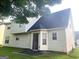 Back exterior showcasing a two-story home with a door to the patio and light-colored siding at 2561 Lancewood Ln, Lithonia, GA 30035