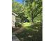 Serene backyard featuring a small deck, lush greenery, and a bird feeder, creating a peaceful outdoor space at 140 Dixie Ln, Covington, GA 30014