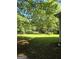 Spacious backyard with lush green lawn and mature trees, perfect for outdoor activities and relaxation at 140 Dixie Ln, Covington, GA 30014