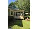 Charming screened-in back porch area with lush green backyard, offering a peaceful spot for relaxation and outdoor dining at 140 Dixie Ln, Covington, GA 30014