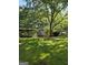 Large backyard featuring a covered shed and mature trees, perfect for outdoor storage or projects at 140 Dixie Ln, Covington, GA 30014