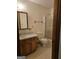 Bathroom featuring vanity, toilet, and shower with glass door; towel rack, and neutral colored walls at 140 Dixie Ln, Covington, GA 30014