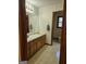 Bathroom with wallpaper, single vanity, toilet, and window at 140 Dixie Ln, Covington, GA 30014