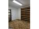 Simple bedroom featuring carpeted floors, a built-in bookshelf and a door leading to another room at 140 Dixie Ln, Covington, GA 30014