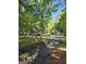 Traditional home featuring a long driveway, mature trees, and a detached garage, offering ample parking and storage at 140 Dixie Ln, Covington, GA 30014