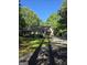 Single-story home with attached garage and extended driveway; surrounded by mature trees and manicured landscaping at 140 Dixie Ln, Covington, GA 30014