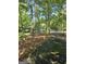 Home surrounded by mature trees and greenery; a long driveway leads to the residence, providing ample parking at 140 Dixie Ln, Covington, GA 30014