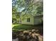 Charming single-story home with vinyl siding and well-maintained lawn surrounded by mature trees at 140 Dixie Ln, Covington, GA 30014