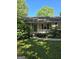 Charming home featuring a cozy front porch with white railing and steps, set amidst lush greenery at 140 Dixie Ln, Covington, GA 30014