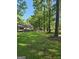 Lush green lawn and trees frame this cozy home with a charming front porch and well-maintained landscaping at 140 Dixie Ln, Covington, GA 30014