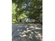 Detached two-car garage with concrete driveway, nestled among mature trees and lush greenery at 140 Dixie Ln, Covington, GA 30014