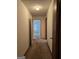 Hallway with carpeted floor leading to room with window at 140 Dixie Ln, Covington, GA 30014