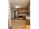 Kitchen with brown cabinets, neutral countertops and flooring, and appliances at 140 Dixie Ln, Covington, GA 30014
