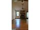 Cozy living room with hardwood floors, a stone fireplace, and large windows providing natural light at 140 Dixie Ln, Covington, GA 30014