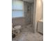 Bathroom featuring updated shower, tile, vanity, toilet, and window, modern and comfortable space at 993 Roosevelt Se Dr, Atlanta, GA 30354