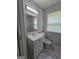 Bathroom features a white vanity, updated lighting, and gray tiling for a clean, modern feel at 993 Roosevelt Se Dr, Atlanta, GA 30354