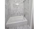Bathroom featuring bright, white shower and tub with gray tiling and chrome fixtures at 993 Roosevelt Se Dr, Atlanta, GA 30354