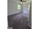 Comfortable bedroom with neutral walls, carpeted floors, two windows, and a ceiling fan for added comfort at 993 Roosevelt Se Dr, Atlanta, GA 30354