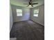 Well-lit bedroom with neutral walls, plush carpeting, and windows overlooking a peaceful outdoor view at 993 Roosevelt Se Dr, Atlanta, GA 30354
