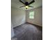 Bedroom features a ceiling fan and neutral carpeting with a window view of the outdoors at 993 Roosevelt Se Dr, Atlanta, GA 30354