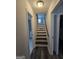 Hallway with staircase and hardwood floors, offering a warm and inviting transition between levels at 993 Roosevelt Se Dr, Atlanta, GA 30354