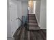 Hallway featuring new dark wood-look floors and stairs with carpeted steps leading to the upper level at 993 Roosevelt Se Dr, Atlanta, GA 30354