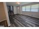 Bright open-concept living room featuring sleek wood-look flooring, a staircase, and an abundance of natural light at 993 Roosevelt Se Dr, Atlanta, GA 30354