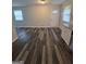 Spacious room with new wood-look floors, multiple windows providing natural light, and neutral walls at 993 Roosevelt Se Dr, Atlanta, GA 30354