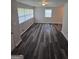 Bright living room featuring stylish gray wood flooring, large windows that let in natural light, and neutral-colored walls at 993 Roosevelt Se Dr, Atlanta, GA 30354
