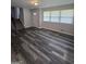 Open living space with modern wood floors, leading to a staircase with carpeted steps and ample natural light at 993 Roosevelt Se Dr, Atlanta, GA 30354