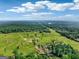 Scenic aerial view of lush greenery, interspersed with trees, a home, and a distant lake at 357 Old Driver Rd, Whitesburg, GA 30185