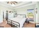 Bedroom with green walls, neutral carpet, a black metal bed frame, and natural light from two windows at 357 Old Driver Rd, Whitesburg, GA 30185