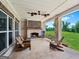Inviting covered patio with brick fireplace, ceiling fans, and scenic backyard views at 357 Old Driver Rd, Whitesburg, GA 30185