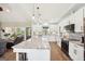 Open kitchen area features a center island, tile backsplash, and stainless steel appliances at 357 Old Driver Rd, Whitesburg, GA 30185
