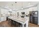 Modern kitchen with white cabinets, granite countertops, stainless appliances, and a large island at 357 Old Driver Rd, Whitesburg, GA 30185
