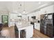 Modern kitchen with white cabinets, granite countertops, a large island, and stainless steel appliances at 357 Old Driver Rd, Whitesburg, GA 30185