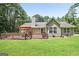 Expansive backyard with a wooden fence, red umbrella, and well-maintained lawn, perfect for outdoor living at 8340 Highway 54, Sharpsburg, GA 30277