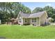 A serene backyard with a spacious lawn, wooden deck, and ample natural light at 8340 Highway 54, Sharpsburg, GA 30277