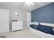 Stylish bedroom featuring a blue accent wall, neutral carpet, and a daybed, complemented by a modern white dresser at 8340 Highway 54, Sharpsburg, GA 30277